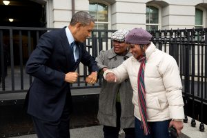 Barack Obama greets GSA staffers with elbow bumps.